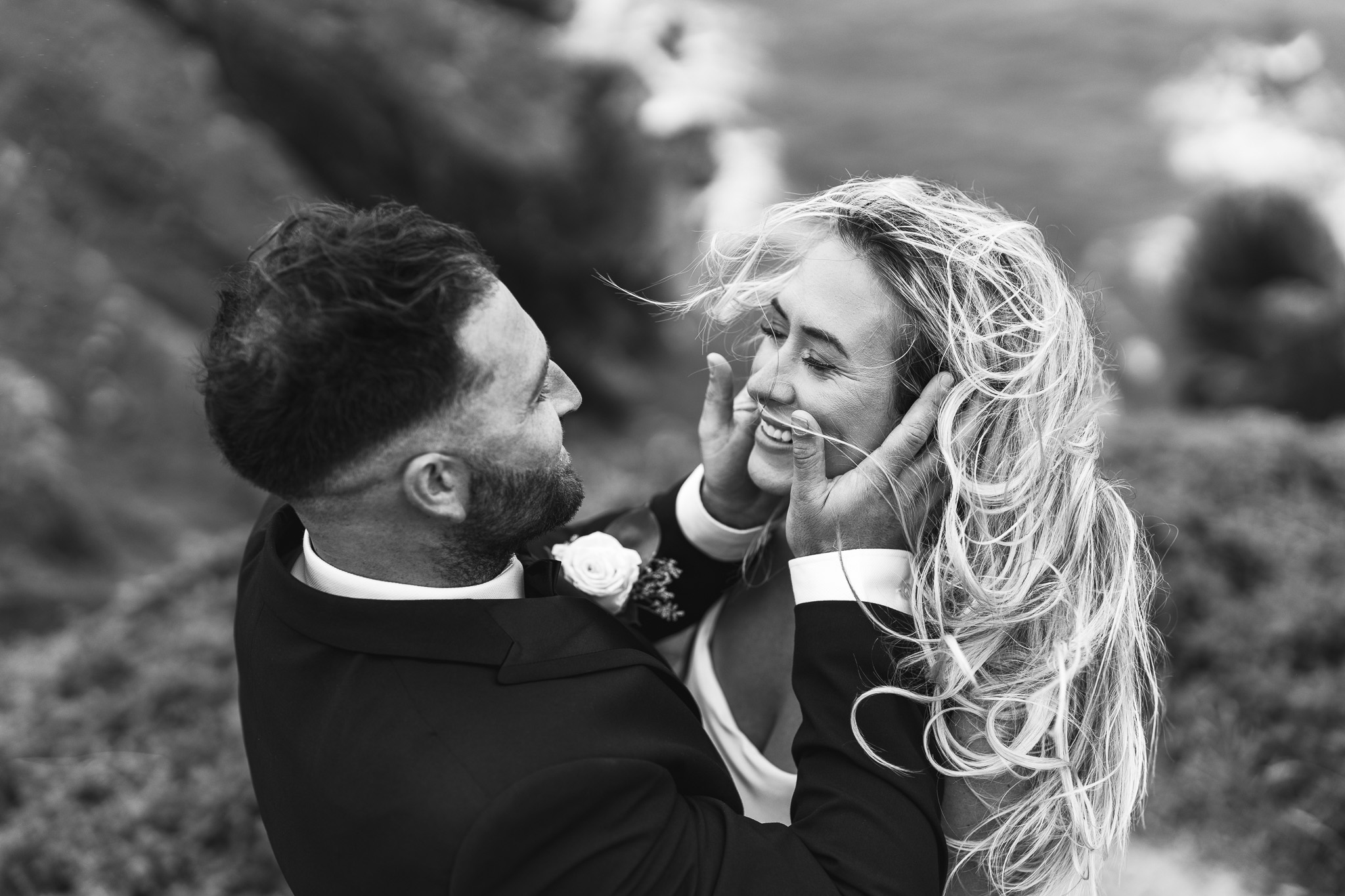 Bride and Groom embracing on the Anglesey coastline during their wedding celebration