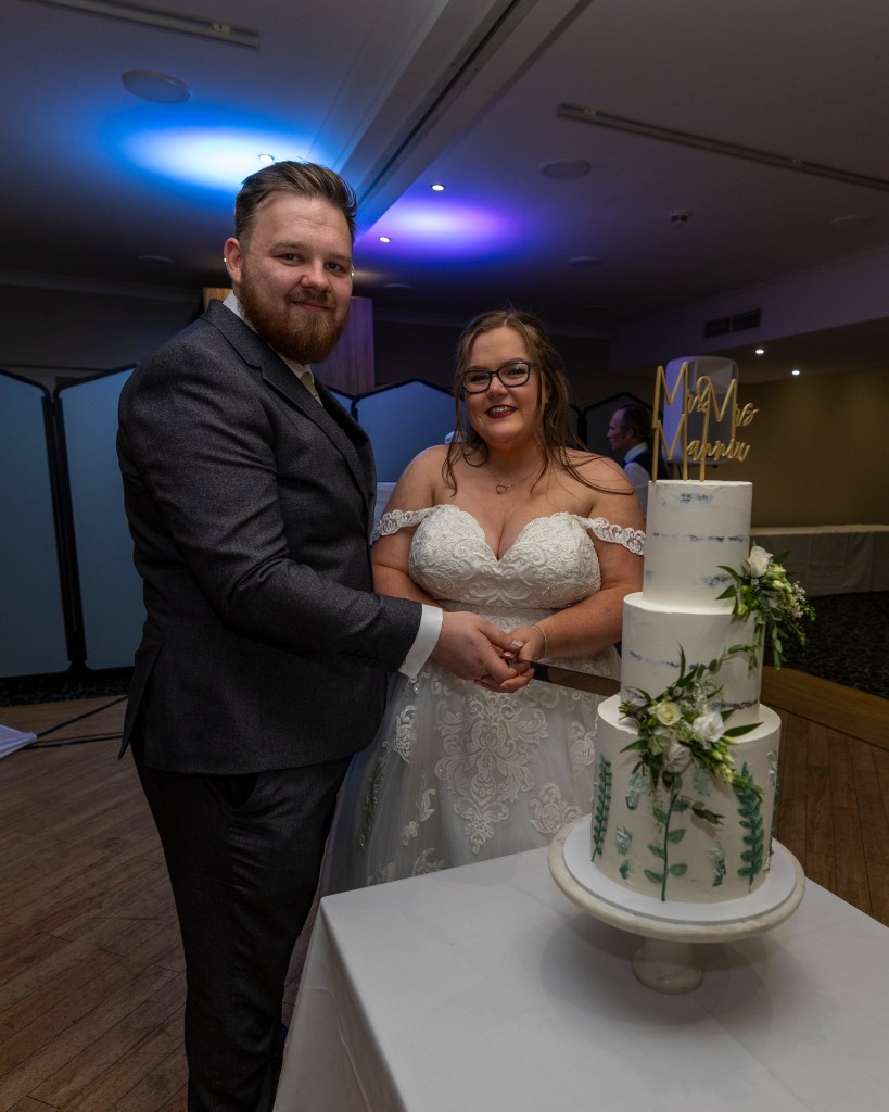 Married couple cutting their wedding cake