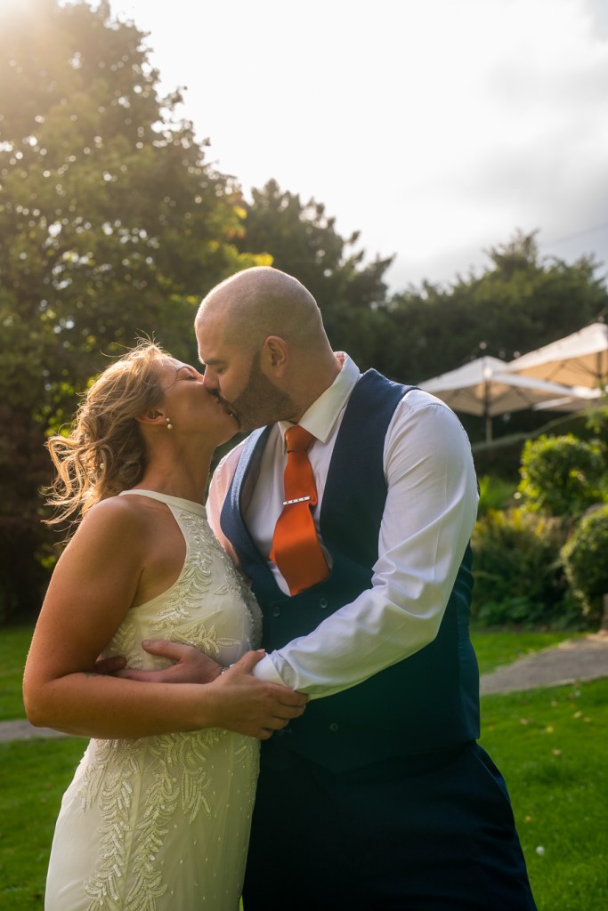 Newly married couple sharing a wedding day kiss.