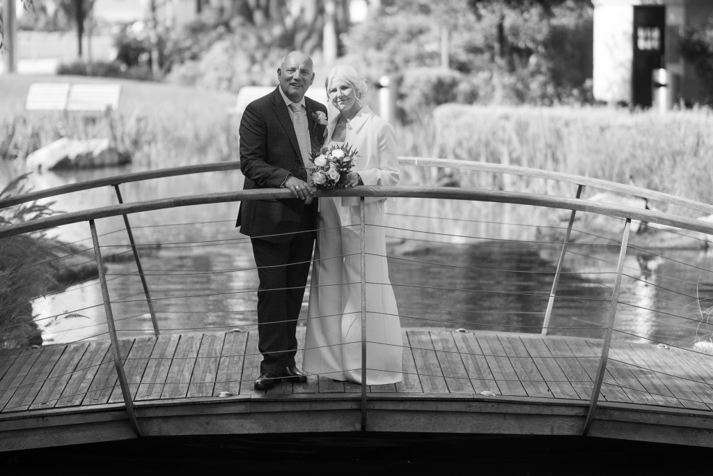 Newly married couple pose for portrait in Gibraltar, Commonwealth Park.